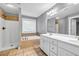 Well-lit bathroom featuring double sink vanity, a soaking tub with tile surround and walk-in shower at 1714 Boulder Walk Se Ln, Atlanta, GA 30316