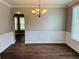 Elegant dining room featuring wood floors, wainscoting, and a decorative light fixture at 1714 Boulder Walk Se Ln, Atlanta, GA 30316