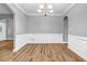 Formal dining area featuring hardwood floors, wainscoting, and an elegant chandelier for added ambiance at 1714 Boulder Walk Se Ln, Atlanta, GA 30316