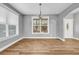Bright dining room featuring hardwood floors, neutral paint, and views of the entry at 1714 Boulder Walk Se Ln, Atlanta, GA 30316