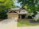 Charming two-story home featuring a well-manicured lawn, a two-car garage, and mature trees at 1714 Boulder Walk Se Ln, Atlanta, GA 30316
