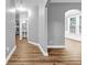 Inviting hallway with hardwood floors leading to powder room and a bright, windowed dining area at 1714 Boulder Walk Se Ln, Atlanta, GA 30316