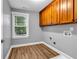 Convenient laundry room with window, wooden cabinets and modern appliances at 1714 Boulder Walk Se Ln, Atlanta, GA 30316