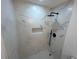 Stylish shower showcasing modern fixtures, gray-white marble tile, and a recessed shelf niche at 1766 Venetian Sw Dr, Atlanta, GA 30311