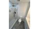 Modern bathroom featuring a black rain shower head, tiled walls, and contemporary fixtures at 1766 Venetian Sw Dr, Atlanta, GA 30311