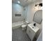 Stylish bathroom with patterned tile flooring, modern vanity, and bathtub with decorative tile surround at 1766 Venetian Sw Dr, Atlanta, GA 30311