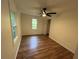 Bedroom with wood-look floors, bright windows, ceiling fan and closet, creating a comfortable space at 1766 Venetian Sw Dr, Atlanta, GA 30311