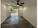 Bright bedroom with modern ceiling fan, and sliding glass door to deck at 1766 Venetian Sw Dr, Atlanta, GA 30311