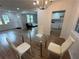Modern dining area featuring a glass table and contemporary lighting fixtures at 1766 Venetian Sw Dr, Atlanta, GA 30311