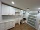 Contemporary kitchen with white cabinets, modern backsplash, and a sliding barn door at 1766 Venetian Sw Dr, Atlanta, GA 30311