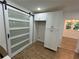 Bright pantry featuring modern cabinetry, wood floors, and a contemporary sliding barn door at 1766 Venetian Sw Dr, Atlanta, GA 30311