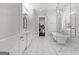 Elegant bathroom featuring a standalone tub, a marble tiled floor, and a glass shower at 1898 Walker Ave, College Park, GA 30337