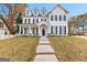 Elegant two-story white home featuring a well-manicured lawn and classic architectural details at 1898 Walker Ave, College Park, GA 30337