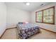 Well-lit bedroom with large window, neutral walls and comfortable carpet, a perfect space at 227 Eton Ct, Mableton, GA 30126