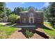 Charming two-story red brick home with symmetrical design, manicured lawn, and traditional architectural details at 227 Eton Ct, Mableton, GA 30126