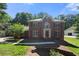 Charming two-story red brick home with symmetrical design, manicured lawn, and traditional architectural details at 227 Eton Ct, Mableton, GA 30126