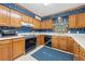 Cozy kitchen featuring wood cabinetry, white countertops, and classic appliances at 227 Eton Ct, Mableton, GA 30126