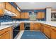 Charming kitchen with wood cabinets, white countertops, and a window providing natural light at 227 Eton Ct, Mableton, GA 30126
