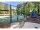 Neighborhood playground features a tennis court, colorful play equipment, and space for running and playing at 227 Eton Ct, Mableton, GA 30126
