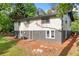Rear of property showcasing walkout basement, gray exterior paint, and an expansive, wooded yard for outdoor activities at 474 Upper Burris Rd, Canton, GA 30114