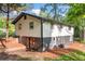 Renovated ranch on basement with walk-out door in backyard filled with mature trees, providing privacy and natural beauty at 474 Upper Burris Rd, Canton, GA 30114