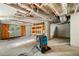 Unfinished basement with concrete floor, exposed ceiling, shelving and a dehumidifier to remove moisture at 474 Upper Burris Rd, Canton, GA 30114