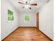 Cozy bedroom with hardwood floors, two windows, and a ceiling fan at 474 Upper Burris Rd, Canton, GA 30114