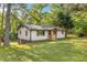 View of renovated home with walk-out basement, natural light, and spacious front lawn with mature trees at 474 Upper Burris Rd, Canton, GA 30114
