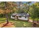 Exterior of home featuring new porch and windows in a wooded lot with ample trees at 474 Upper Burris Rd, Canton, GA 30114