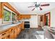 Spacious kitchen with wood cabinets, tile backsplash, and a view into the living room at 474 Upper Burris Rd, Canton, GA 30114