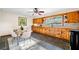 Bright kitchen with wood cabinets, slate tile floors, and a dining area at 474 Upper Burris Rd, Canton, GA 30114