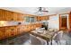 Eat-in kitchen features knotty pine cabinets, modern appliances, and a ceiling fan at 474 Upper Burris Rd, Canton, GA 30114