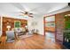 Inviting living room featuring a brick accent wall and hardwood flooring at 474 Upper Burris Rd, Canton, GA 30114