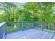 Inviting outdoor deck overlooking a lush green yard surrounded by beautiful trees at 6625 Peppermill Ln, South Fulton, GA 30349