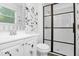Updated bathroom featuring a modern glass shower door and floral decals at 6625 Peppermill Ln, South Fulton, GA 30349
