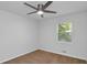 This carpeted bedroom features a ceiling fan and natural light from the window at 6625 Peppermill Ln, South Fulton, GA 30349