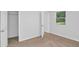This bedroom features neutral carpeting, and a window overlooking the yard and a closet at 6625 Peppermill Ln, South Fulton, GA 30349