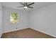 This carpeted bedroom features a ceiling fan and window for natural light at 6625 Peppermill Ln, South Fulton, GA 30349