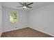 This bedroom features a ceiling fan, neutral carpeting, and a window overlooking the yard at 6625 Peppermill Ln, South Fulton, GA 30349