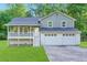 Charming split-level home with a two-car garage, front porch, and well-manicured lawn at 6625 Peppermill Ln, South Fulton, GA 30349