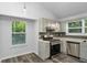 Updated kitchen featuring stainless steel appliances, sleek countertops, and views from the window at 6625 Peppermill Ln, South Fulton, GA 30349