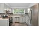 Updated kitchen featuring stainless steel appliances, sleek countertops, and a mosaic backsplash at 6625 Peppermill Ln, South Fulton, GA 30349
