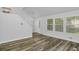 Open-concept living room with hardwood floors and ample natural light from large windows at 6625 Peppermill Ln, South Fulton, GA 30349