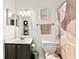 Bright bathroom featuring a modern vanity, decorative mirror, and stylish shower curtain at 6900 Roswell Rd # 3N, Atlanta, GA 30328