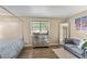 The primary bedroom has a four-poster bed, sofa, dresser and large window at 6900 Roswell Rd # 3N, Atlanta, GA 30328