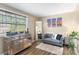Cozy bedroom with a comfortable gray loveseat, a window, and a mirrored dresser at 6900 Roswell Rd # 3N, Atlanta, GA 30328