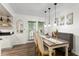 Bright dining area adjacent to the kitchen with modern light fixtures and hardwood floors at 6900 Roswell Rd # 3N, Atlanta, GA 30328
