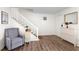 Bright entryway features hardwood floors, a staircase, and a stylish storage cabinet at 6900 Roswell Rd # 3N, Atlanta, GA 30328