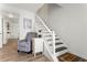 Inviting entryway with gray chair, stairway to the second floor, and view into other rooms at 6900 Roswell Rd # 3N, Atlanta, GA 30328