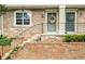 Charming brick townhouse with wreaths adorning the front doors and a lovely front entrance at 6900 Roswell Rd # 3N, Atlanta, GA 30328